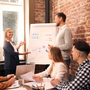 Businesswoman having meeting with her employees in office. Lady boss